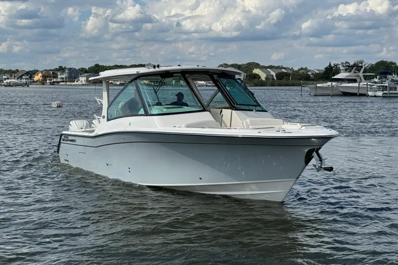 Slide: The Image of 2026 Grady-White Freedom 345 boat cruising on a calm lake under cloudy skies. - 11