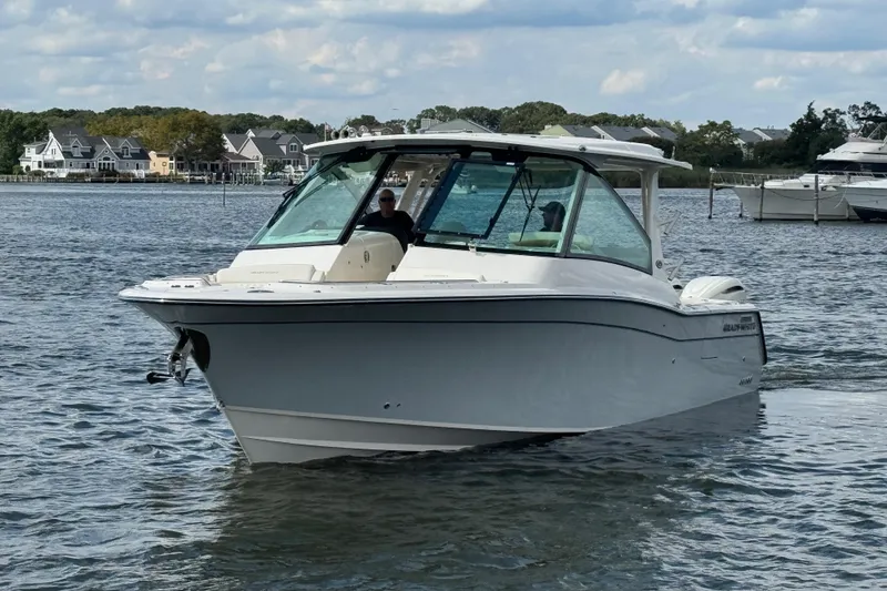 Slide: The Image of 2026 Grady-White Freedom 345 boat on water, with houses and boats in the background. - 15