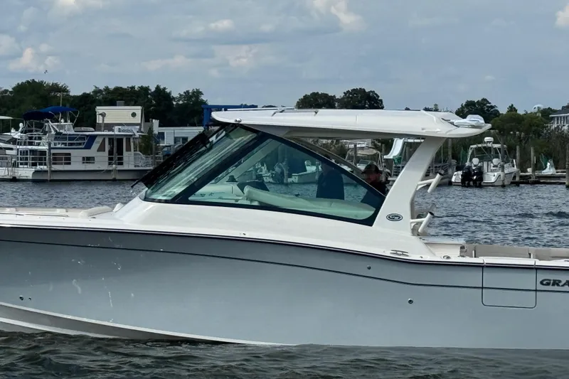 Slide: The Image of 2026 Grady-White Freedom 345 boat on water, with marina background. - 17