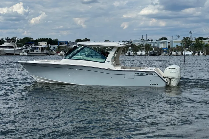 Slide: The Image of 2026 Grady-White Freedom 345 boat on water, side view, cloudy sky background. - 18