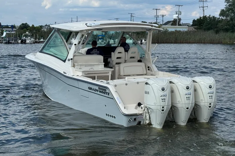 Slide: The Image of 2026 Grady-White Freedom 345 boat with triple Yamaha 350 engines on water. - 21