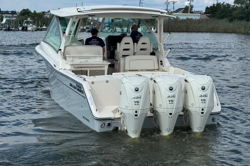 Slide: The Image of 2026 Grady-White Freedom 345 boat with triple Yamaha 350 V6 engines on water. - 22