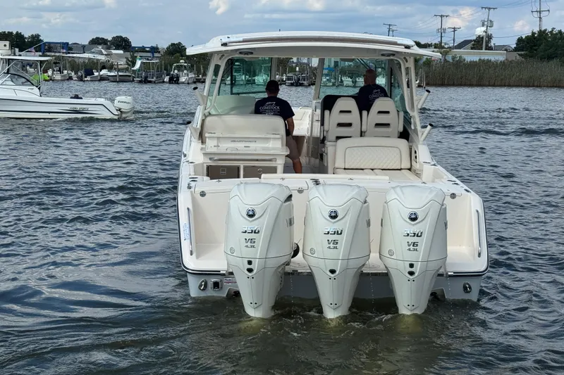 Slide: The Image of 2026 Grady-White Freedom 345 boat with triple Yamaha 350 V6 engines on water. - 23