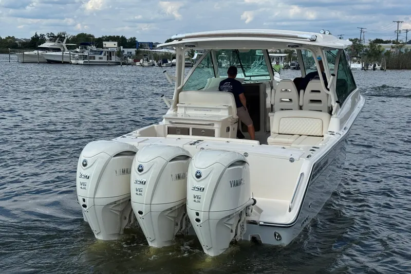 Slide: The Image of 2026 Grady-White Freedom 345 boat with triple Yamaha 350 engines on the water. - 24