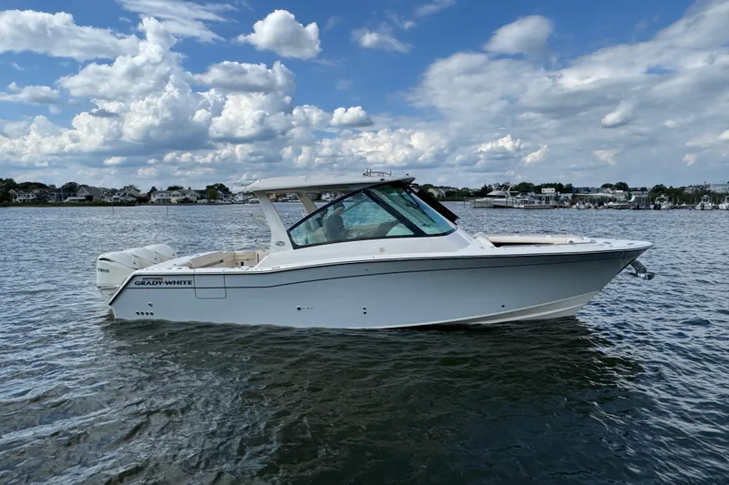 Slide: The Image of 2026 Grady-White Freedom 345 boat on calm water under a partly cloudy sky. - 28