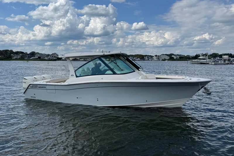Slide: The Image of 2026 Grady-White Freedom 345 boat on calm water under a partly cloudy sky. - 29