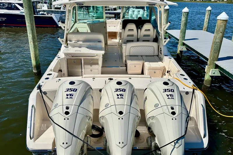 Slide: The Image of 2026 Grady-White Freedom 345 boat with triple 350 V6 engines docked at marina. - 32