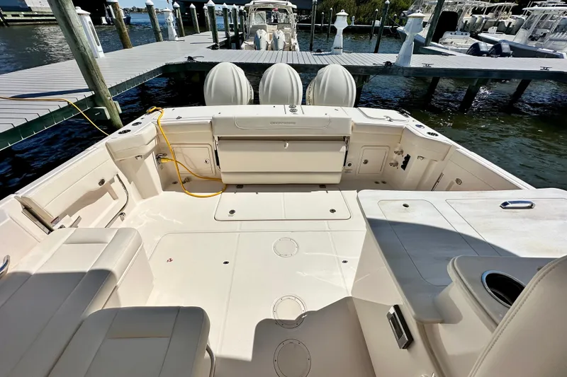 Slide: The Image of 2026 Grady-White Freedom 345 boat interior at dock, featuring spacious seating and storage. - 34