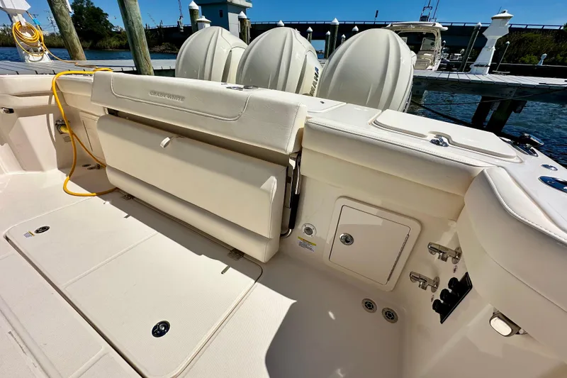 Slide: The Image of 2026 Grady-White Freedom 345 boat interior with seating and engine view at dock. - 35