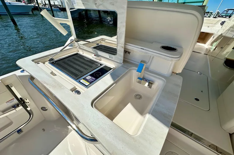 Slide: The Image of 2026 Grady-White Freedom 345 boat with outdoor sink and grill setup. - 37
