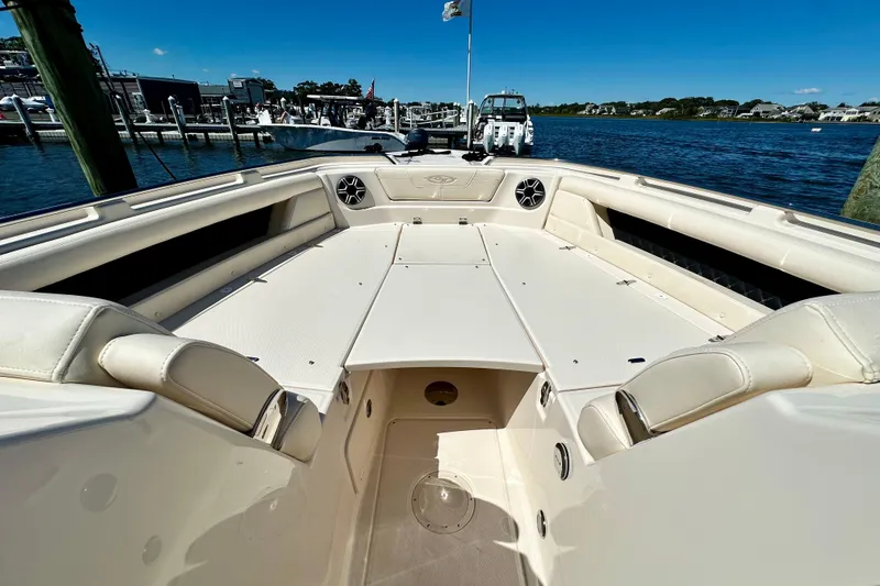 Slide: The Image of 2026 Grady-White Freedom 345 boat interior, spacious seating, docked by the water. - 46