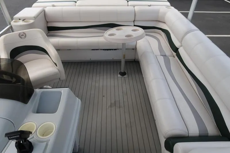 Slide: The Image of 2001 Harris Super Sunliner 240 boat interior with white seating and cup holders. - 11