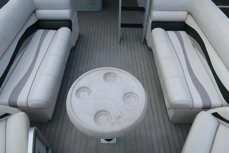 Slide: The Image of Interior of a 2001 Harris Super Sunliner 240 pontoon boat with seating and table. - 12