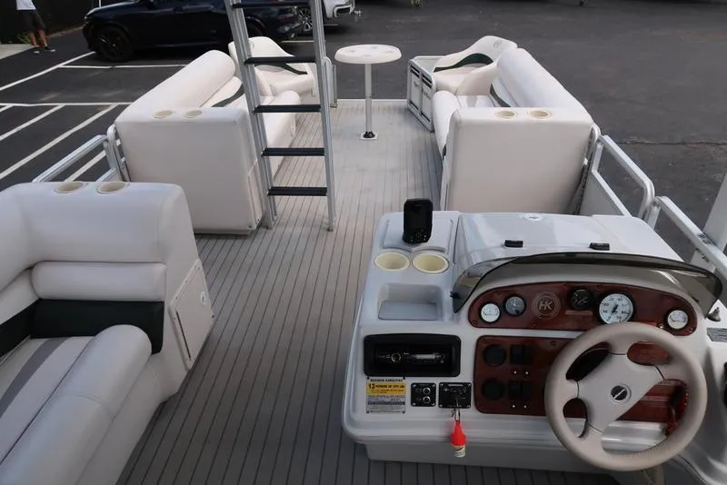 Slide: The Image of 2001 Harris Super Sunliner 240 pontoon boat interior with helm, seating, and table. - 16