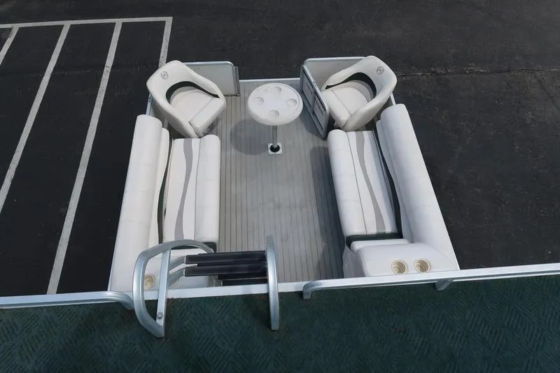 Slide: The Image of Pontoon boat interior with white seating, table, and cup holders, Harris Super Sunliner 240, 2001 model. - 18