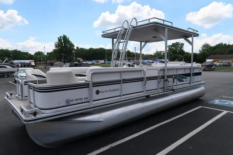 Slide: The Image of 2001 Harris Super Sunliner 240 pontoon boat with canopy, parked outdoors under a blue sky. - 3