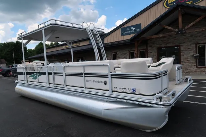Slide: The Image of 2001 Harris Super Sunliner 240 pontoon boat parked outside a dealership. - 5