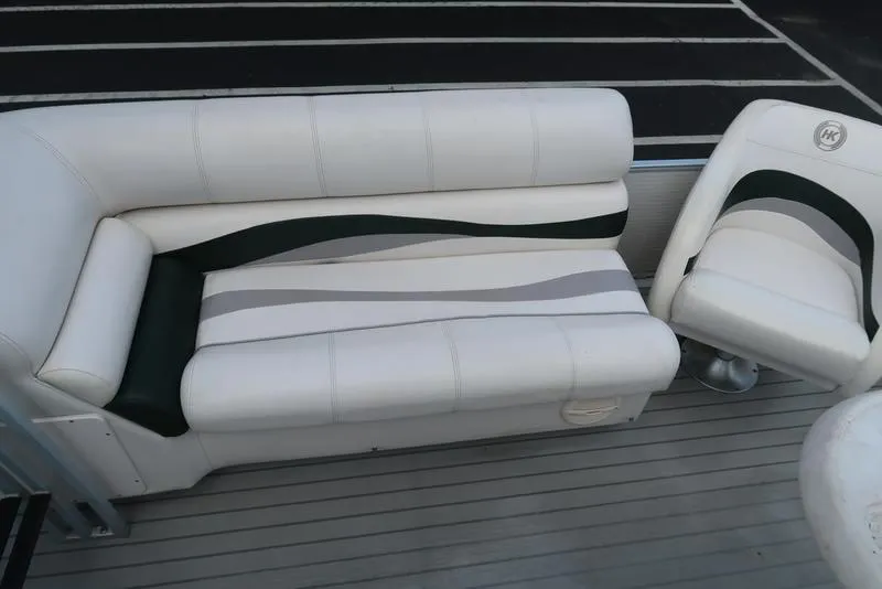 Slide: The Image of 2001 Harris Super Sunliner 240 boat seating with white and gray upholstery. - 7