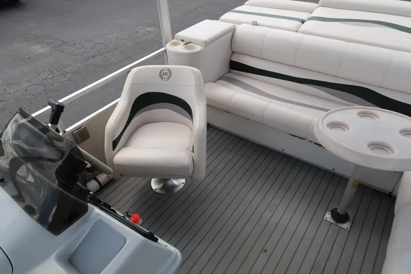 Slide: The Image of 2001 Harris Super Sunliner 240 boat interior with white seating and steering console. - 9