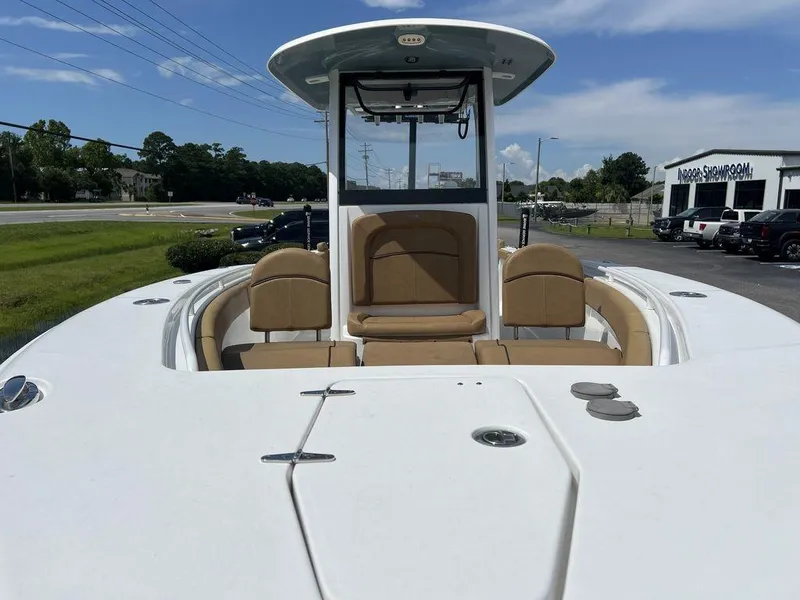 Slide: The Image of 2020 Sea Hunt Ultra 275 SE boat with tan seating, parked outdoors. - 10