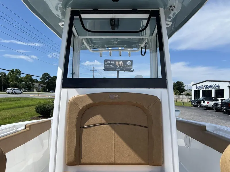 Slide: The Image of 2020 Sea Hunt Ultra 275 SE boat interior with tan seating and clear skies. - 11