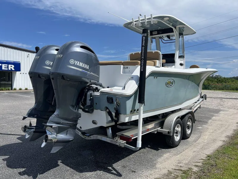 Slide: The Image of 2020 Sea Hunt Ultra 275 SE boat with dual Yamaha engines on a trailer. - 12