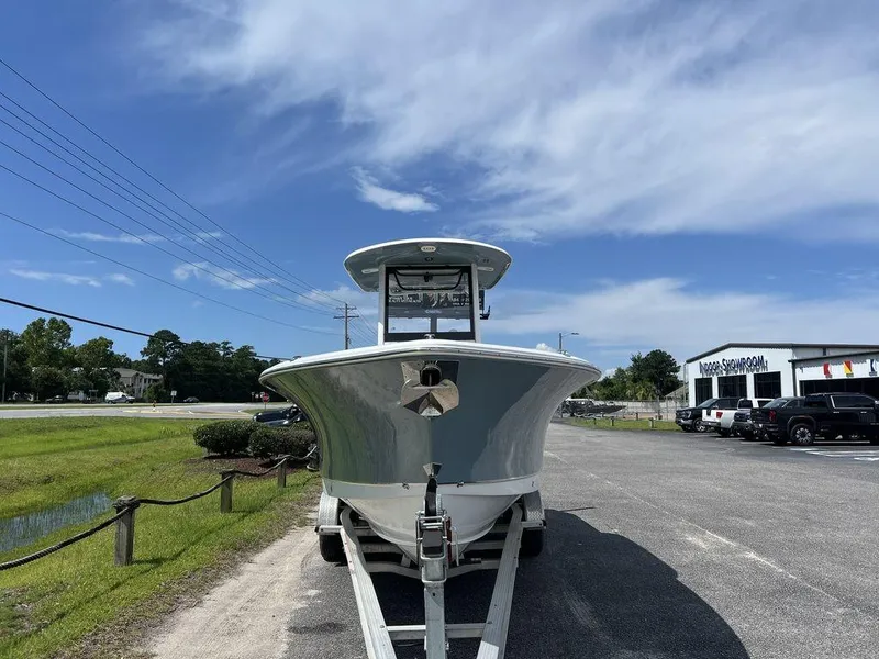 Slide: The Image of 2020 Sea Hunt Ultra 275 SE boat on trailer, parked outdoors under a clear sky. - 13