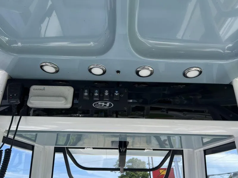 Slide: The Image of 2020 Sea Hunt Ultra 275 SE dashboard with Garmin device and control panel. - 14