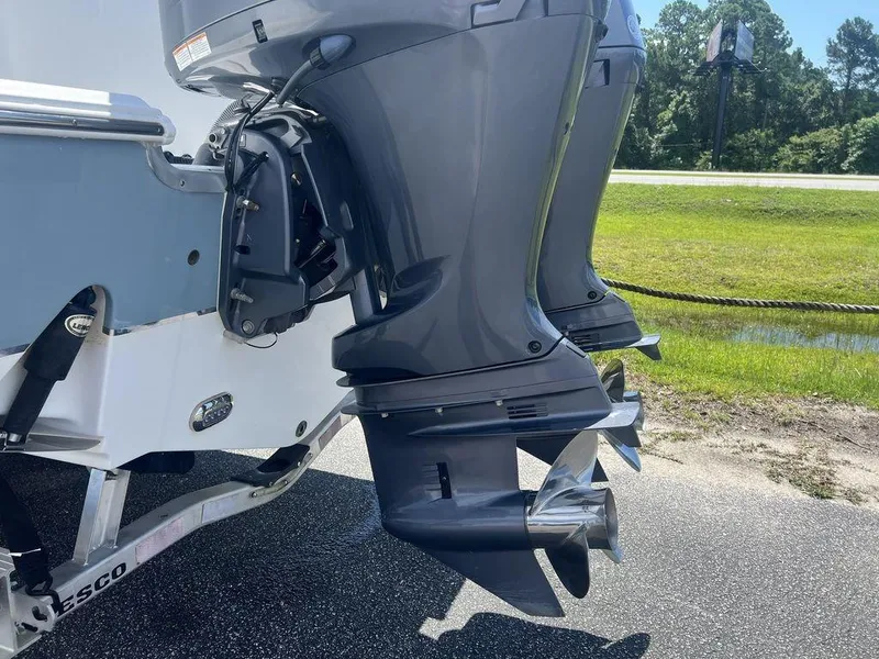 Slide: The Image of Twin outboard motors on a 2020 Sea Hunt Ultra 275 SE boat, parked on a trailer. - 16