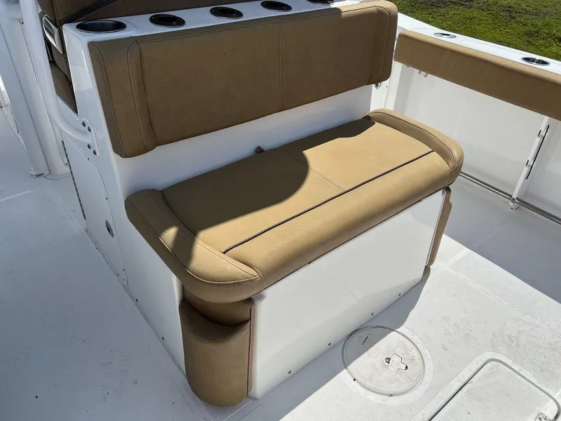 Slide: The Image of 2020 Sea Hunt Ultra 275 SE boat seating with tan cushions and cup holders. - 18