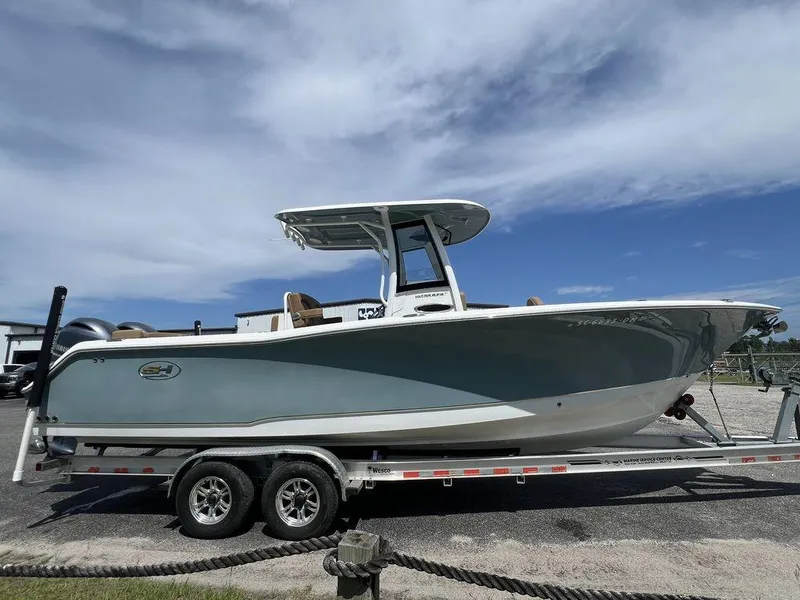 Slide: The Image of 2020 Sea Hunt Ultra 275 SE boat on trailer under clear sky. - 2