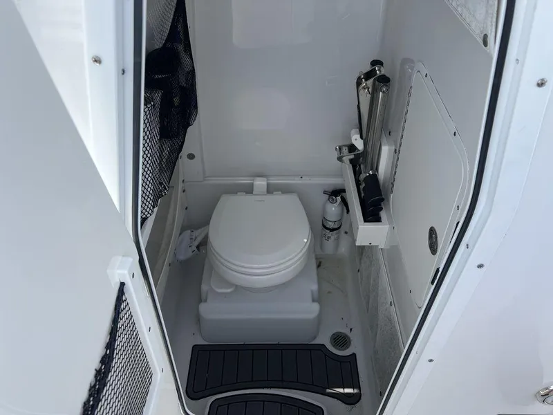 Slide: The Image of 2020 Sea Hunt Ultra 275 SE boat interior with compact marine toilet. - 21