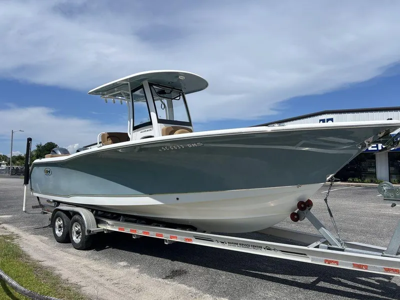 Slide: The Image of 2020 Sea Hunt Ultra 275 SE boat on trailer under clear sky. - 4