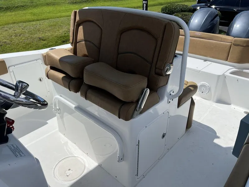 Slide: The Image of 2020 Sea Hunt Ultra 275 SE boat interior with brown seating and steering wheel. - 6