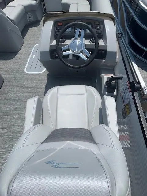 Slide: The Image of 2024 Bennington 23 SXSWB boat interior with steering wheel and captain's chair. - 7