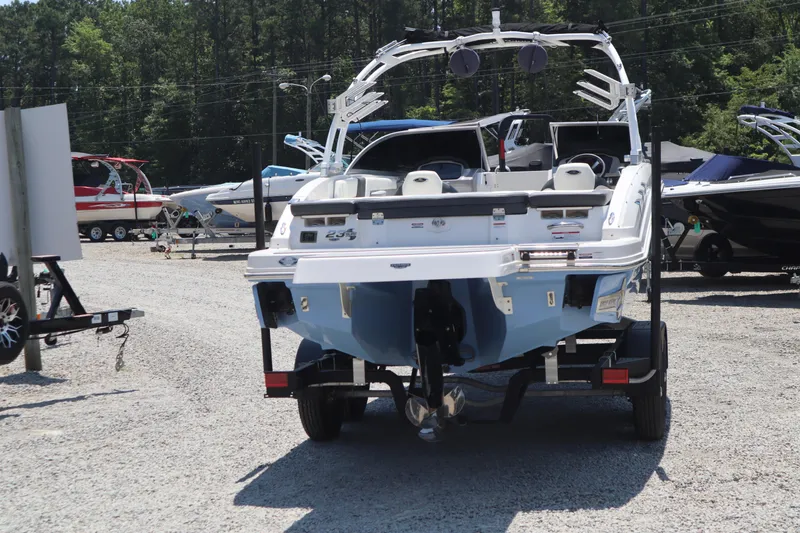 Slide: The Image of 2023 Chaparral 23 Surf boat on trailer in outdoor showroom. - 1