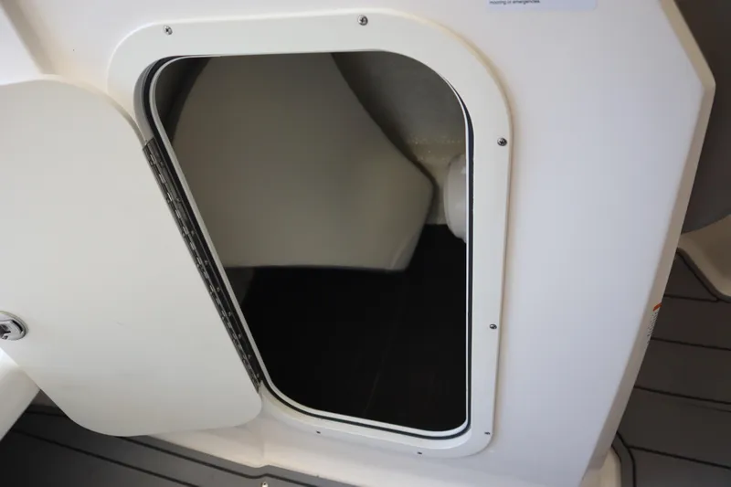 Slide: The Image of 2023 Chaparral 23 Surf boat storage compartment with open door. - 11