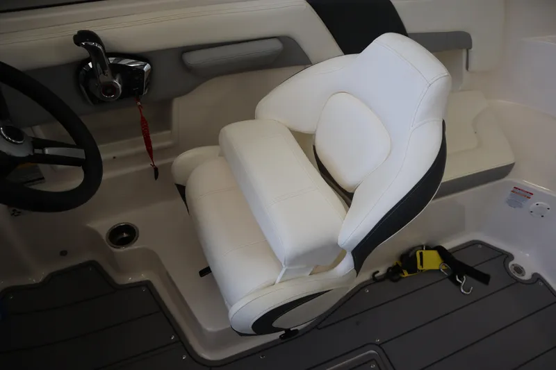 Slide: The Image of 2023 Chaparral 23 Surf boat interior with white captain's seat and control panel. - 17