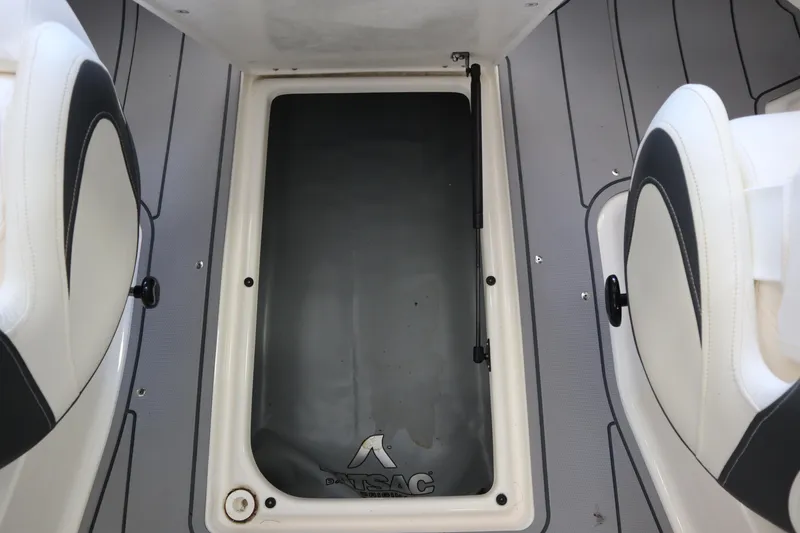 Slide: The Image of 2023 Chaparral 23 Surf boat interior storage compartment with cushioned seats. - 20