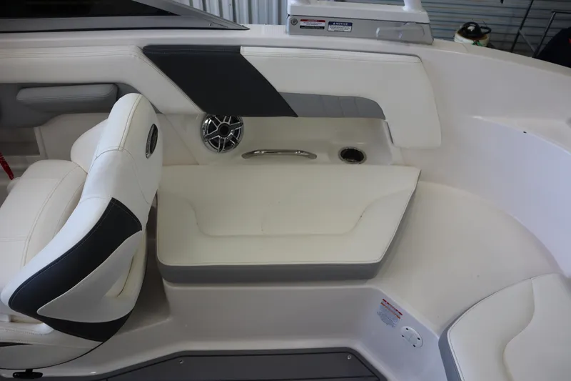 Slide: The Image of 2023 Chaparral 23 Surf boat interior with white seating and speaker detail. - 22