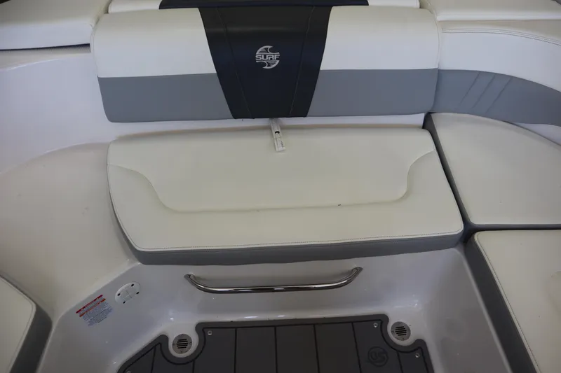 Slide: The Image of 2023 Chaparral 23 Surf boat interior seating with gray and white upholstery. - 24