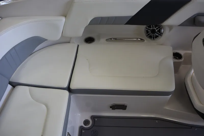 Slide: The Image of 2023 Chaparral 23 Surf boat interior seating with white and gray upholstery. - 26