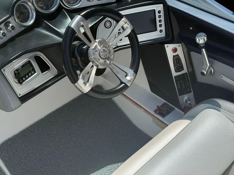 Slide: The Image of 2016 MasterCraft X46 boat dashboard with steering wheel and control panel. - 10