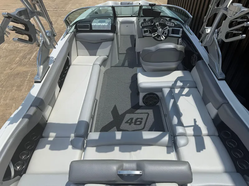 Slide: The Image of 2016 MasterCraft X46 boat interior with sleek seating and modern dashboard. - 5