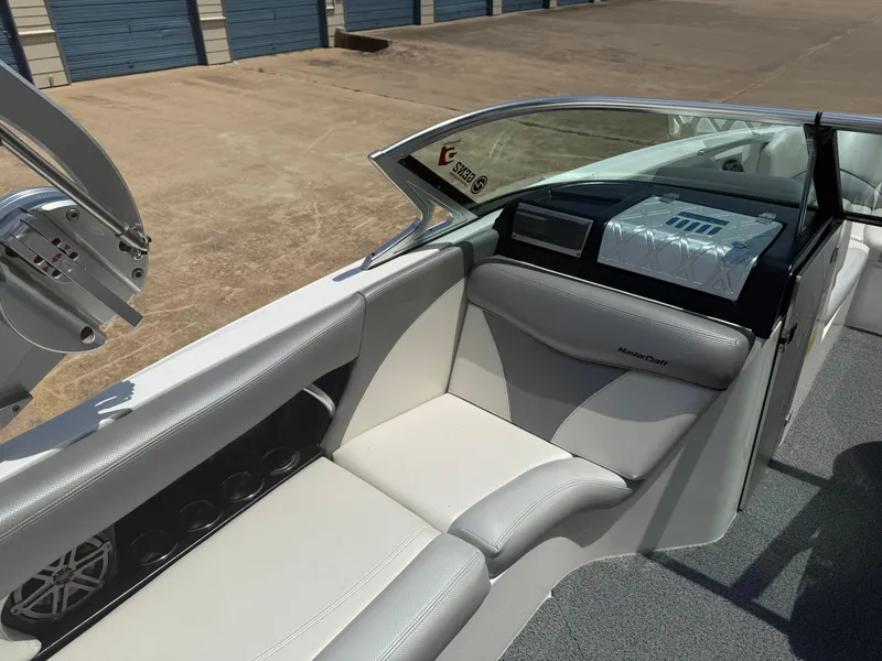 Slide: The Image of 2016 MasterCraft X46 boat interior with white seating and storage compartments. - 7