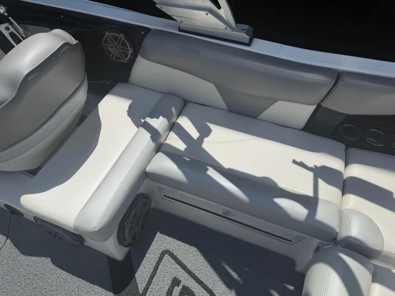 Slide: The Image of 2016 MasterCraft X46 interior seating with gray upholstery and speaker detail. - 9