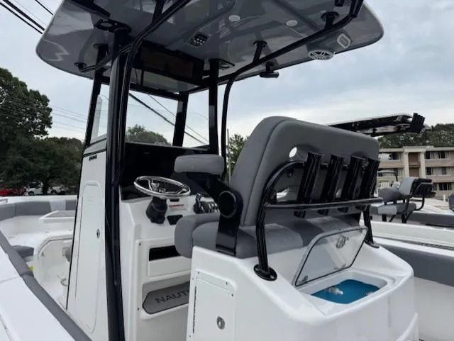 Slide: The Image of 2025 NauticStar 242 Offshore boat interior with modern helm and seating. - 4