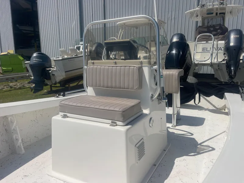 Slide: The Image of 2023 Intruder ISLAND CLASSIC 17 boat interior with seating and controls. - 14