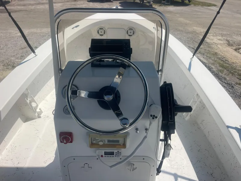 Slide: The Image of 2023 Intruder ISLAND CLASSIC 17 boat console with steering wheel and controls. - 17