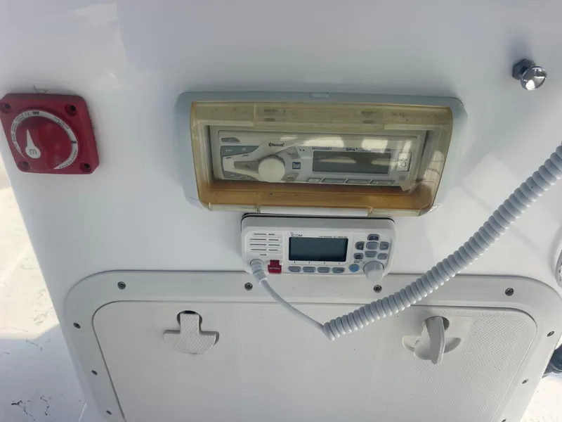 Slide: The Image of Control panel of 2023 Intruder ISLAND CLASSIC 17 boat with radio and switches. - 18